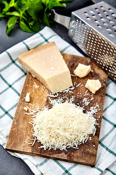 istock Piece of a parmesan and grated cheese 585506558