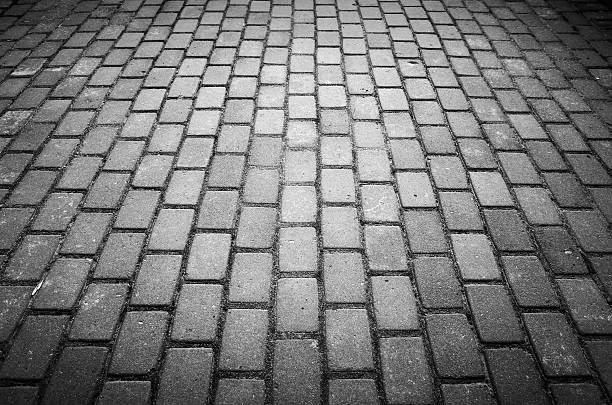 istock Gray urban cobble road background 585507428