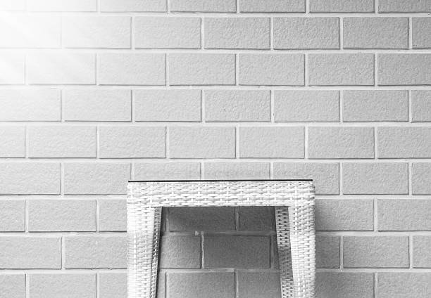 Closeup wood weave table on blurred brown brick wall texture background , beautiful interior in relaxation of house concept in black and white tone