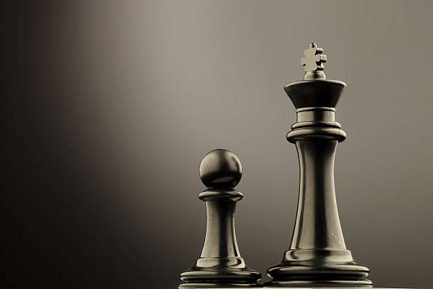 istock black king chess piece near pawn 585508540