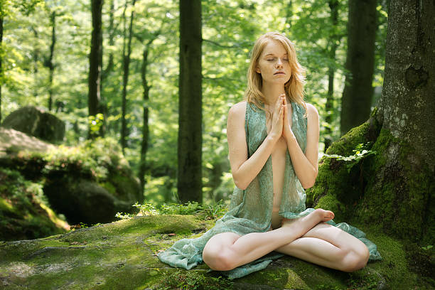 istock woman meditating and doing yoga 585509142