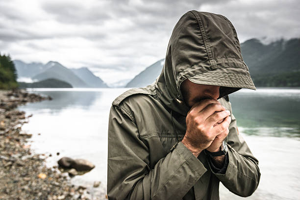 Solitude man pensive on the lake side Solitude man pensive on the lake side spirituality adventure searching tranquil scene stock pictures, royalty-free photos & images