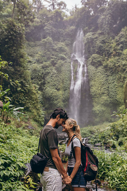 istock Affectionate young couple standing together in forest 585510116