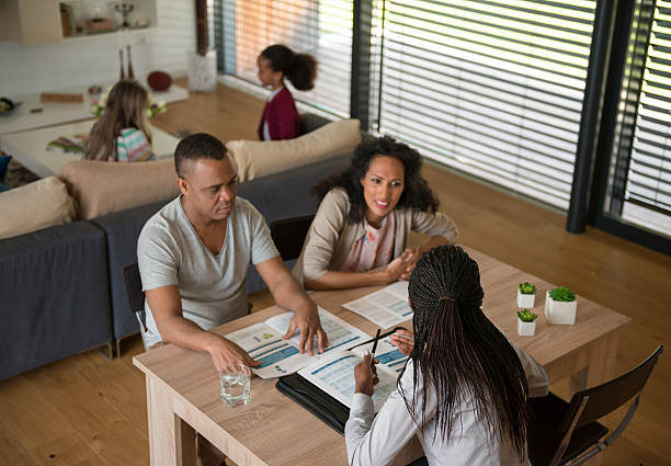 istock Insurance Agent Talking To Couple 585510900