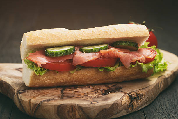 istock sandwich with salmon and vegetables on wood table 585511066
