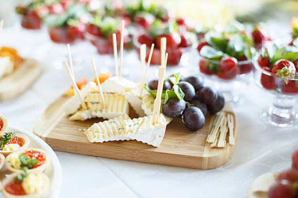 Plate of Cheese with grape on wooden plate at a restaurant