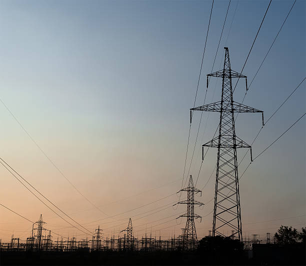 istock pylons power transmission at sunset closeup 585515452