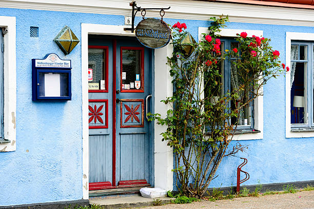 Ystad, Sweden - August 1, 2016: The entrance to the inn Pilgrandens Wardshus with red roses beside the door. The house dates back to 1848.