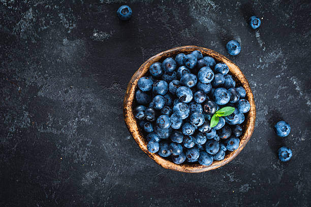 istock Blueberries in bowl, overhead view 585517318