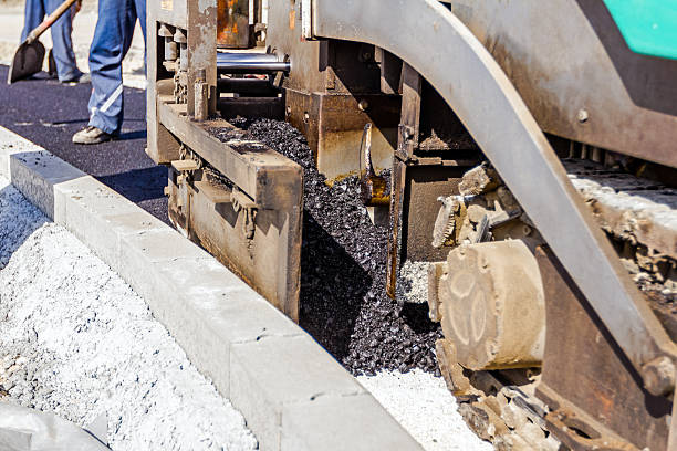 istock Metal auger for supply with hot asphalt in spreading machine. 585519864