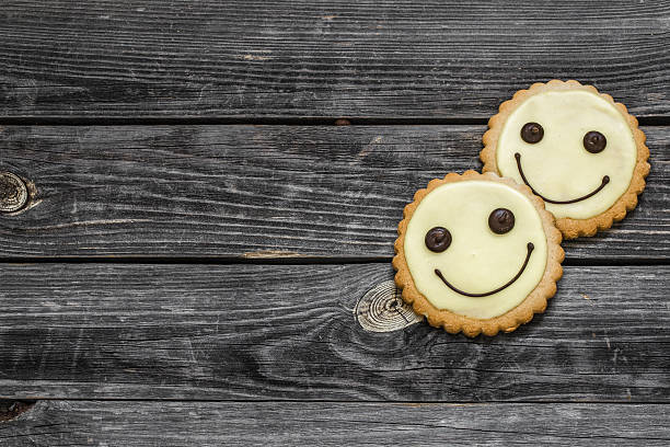 istock cookies smile on a beautiful wooden background 585520706