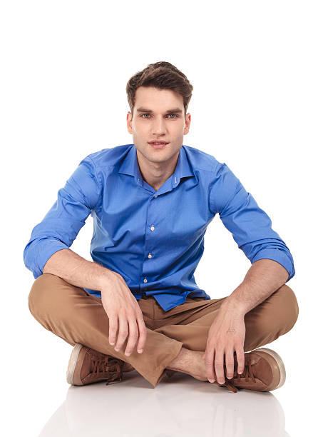 istock Handsome young man sitting with his legs crossed 585520840