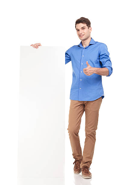 istock young fashion man holding a empty board 585520904