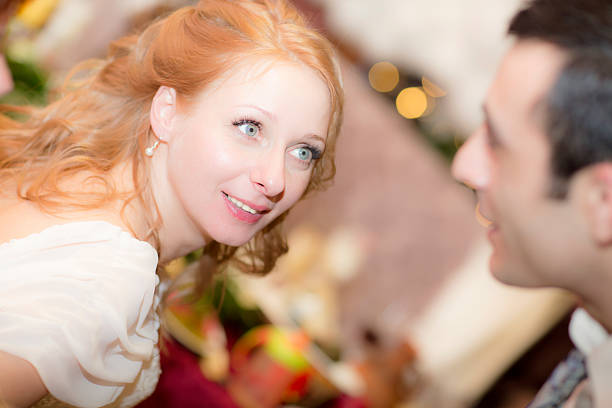 The bride and groom look at each other. Wedding portrait woman in the restaurant. 