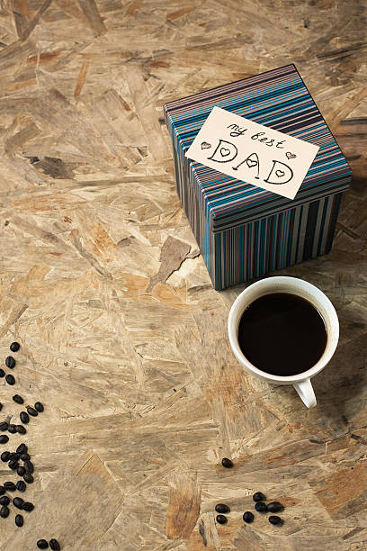 istock Greetings happy father's day. Box and coffee on the table 585522212