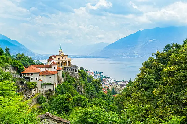 General view of Locarno with Madonna del sasso from above. Madonna del sasso is a pilgrimage church above the city of Locarno. It is one of the most important religious and historical sites in Locarno, Switzerland.