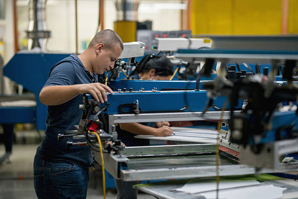 istock Man textile printing at a factory 585525402