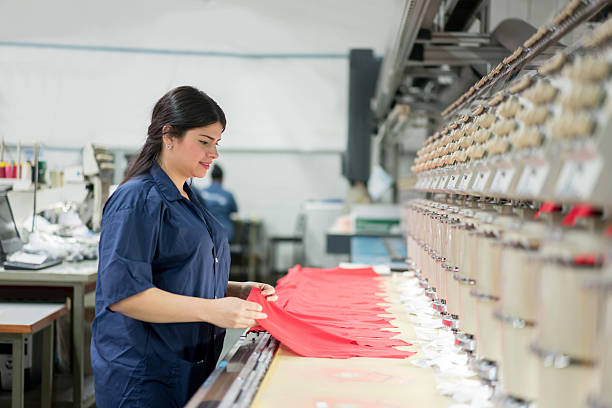 istock Woman operating the embroidery machine 585525408