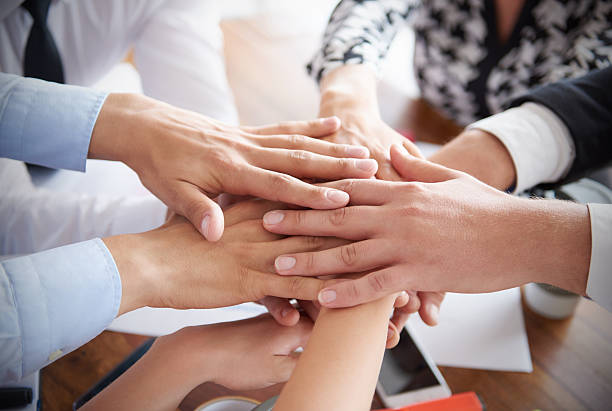 istock Close up of stack of human hands 585526178