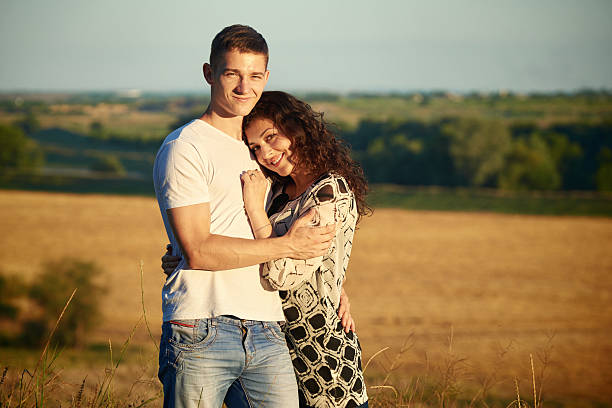 istock smiling couple having fun over evening, love and friendship concept 585583264