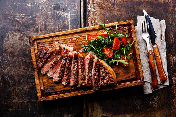 istock Sliced grilled steak and salad 585583496