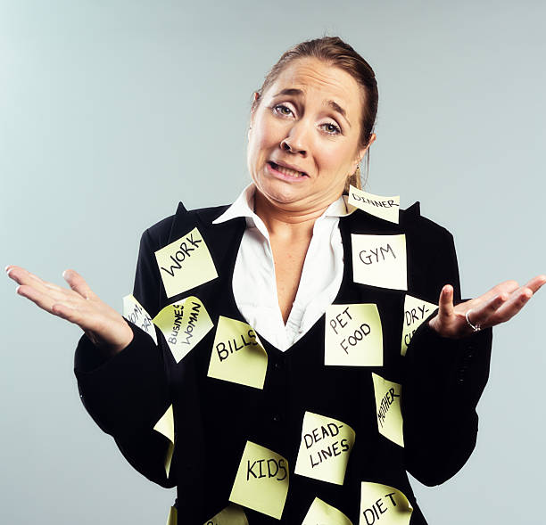 istock Desperate woman covered in task reminders cannot cope any longer 585583522