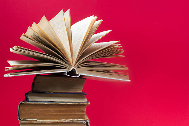 istock Open book, stack of hardback books. Back to school 585586250