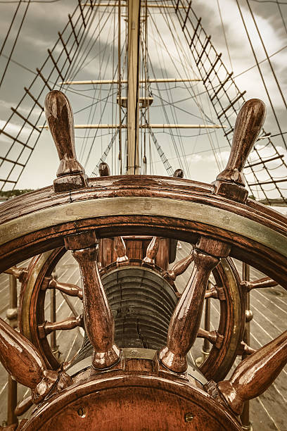 Retro styled image of the steering wheel of a sail boat