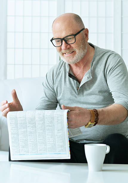 istock portrait of senior man with newspaper 585586772