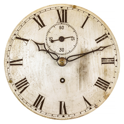 Sepia toned image of an old clock face isolated on a white background