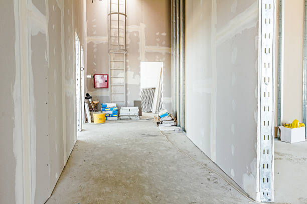 Gypsum wall under construction, ready for next step View through corridor of gypsum, plasterboard walls under construction. painted drywall texture stock pictures, royalty-free photos & images
