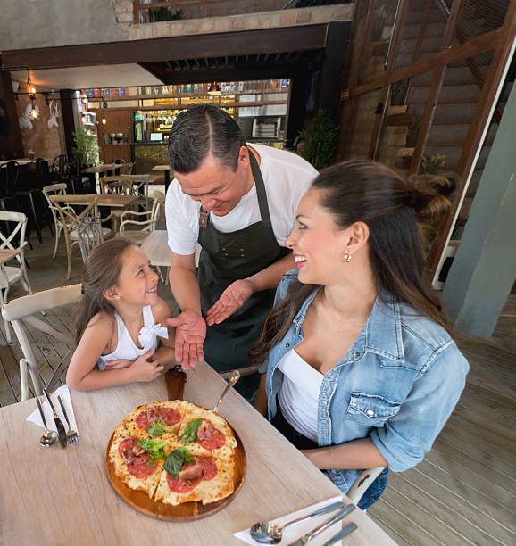 istock Waiter serving clients at an Italian restaurant 585588186