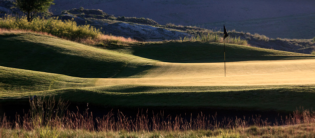 A beautiful prairie golf course in dramatic evening light. Golf courses on the prairies, especially if they are shaped and designed well, can reflect the beautiful rolling links courses of Scotland, Ireland, and Wales. This golf course in Alberta, Canaa is a rural \