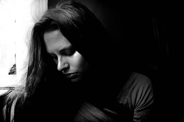 istock young woman in deep thought, thinking, feeling, loss 585591532