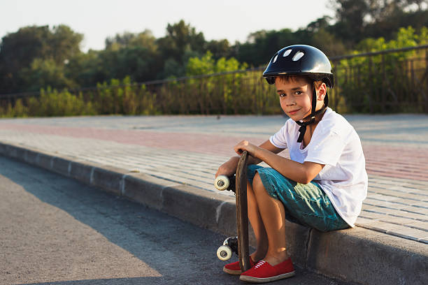 istock Boy sit with a skateboard outdoors 585591892