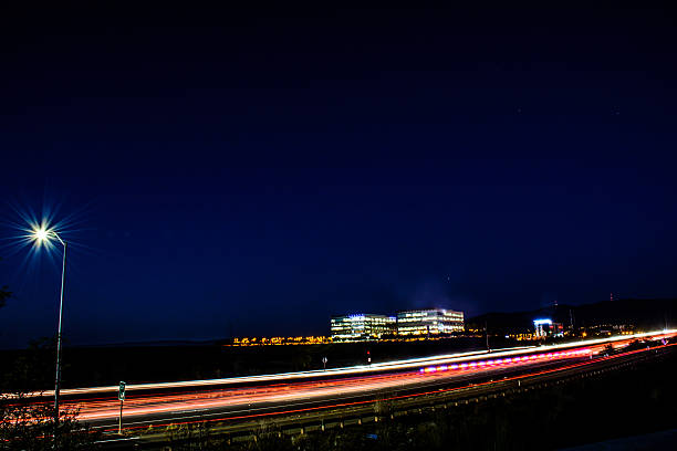 istock Busy Silicon Vally Night Freeway and Office Cityscape 585592552