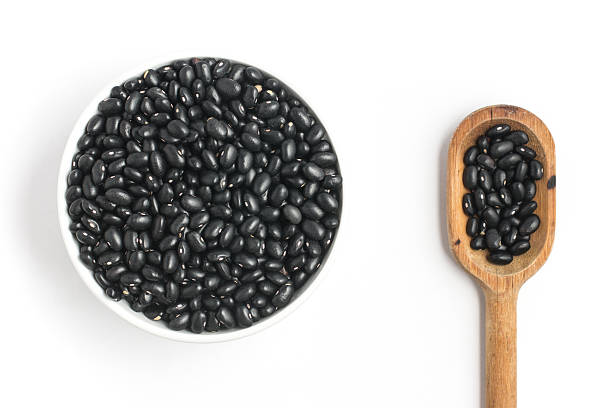 istock Black beans into a bowl in white background. Phaseolus vulgaris 585592822