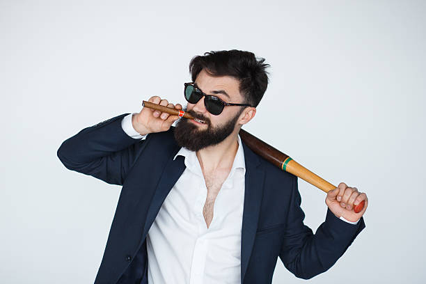 Angry bearded man in black suit and sunglasses Bearded collector man with serious face, sunglasses, black suit, cigar and baseball bat isolated on white background bouncer security staff stock pictures, royalty-free photos & images