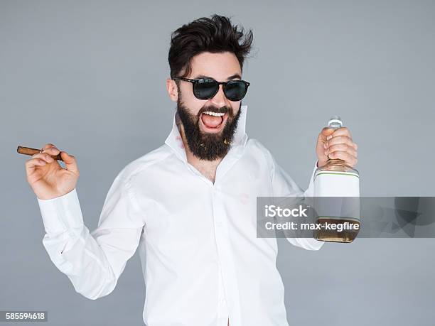 Man Holding A Bottle Of Whiskey And Cigar Stock Photo - Download Image Now - Men, Drunk, Bottle