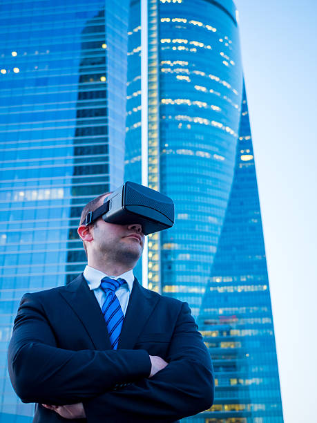 istock Confident businessman using virtual reality glasses in a business center 585596142