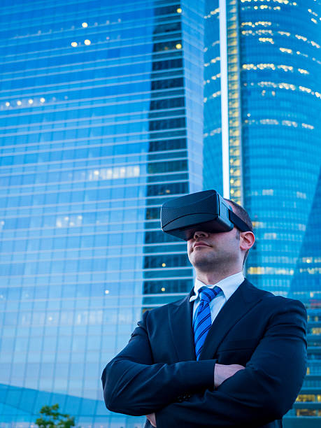 istock Confident businessman using virtual reality glasses in a business center 585596168