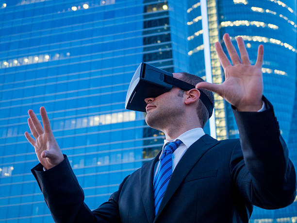 istock Businessman using virtual reality glasses in a business center 585596218