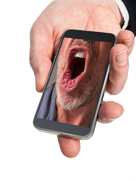 Close Up Photo of Angry Man's Mouth on Mobile Phone. stock photo