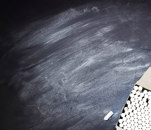 istock Box with pieces of chalk on a  blackboard 585598252