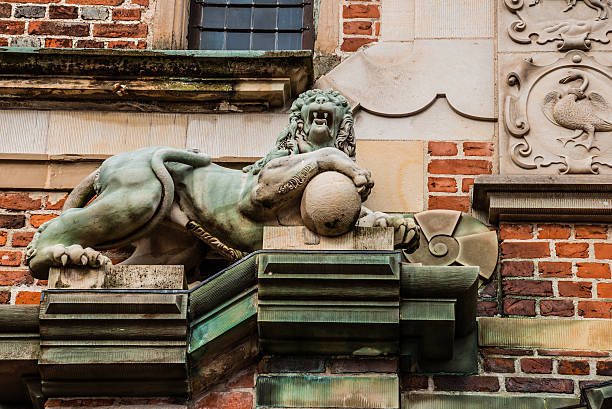 Hillerod, Denmark - September, 23th, 2015. Copper lion sculpture on brick wall of Frederiksborg castle near Copenhagen.