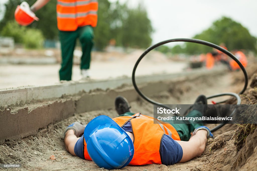 Accident at work Young building worker injured at construction site Misfortune Stock Photo