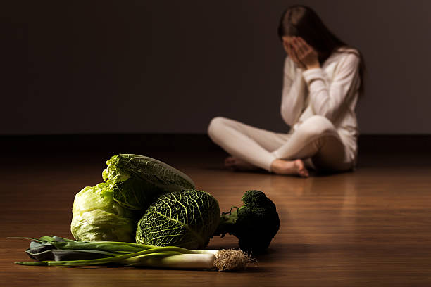 istock Woman suffering from eating disorder 585598622