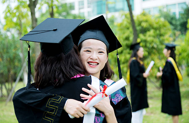 istock Graduates hugging outdoors 585598934