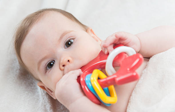 istock Small baby girl looking at toy 585604122