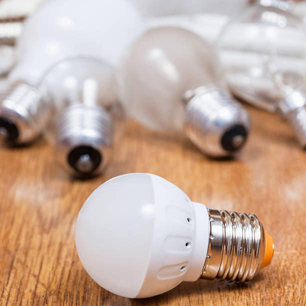 istock new LED lamp and used bulbs on table 585605316